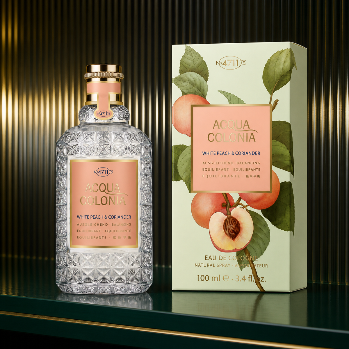 4711 Acqua Colonia White Peach and Coriander Eau de Cologne 100ml bottle and box on an emerald shelf