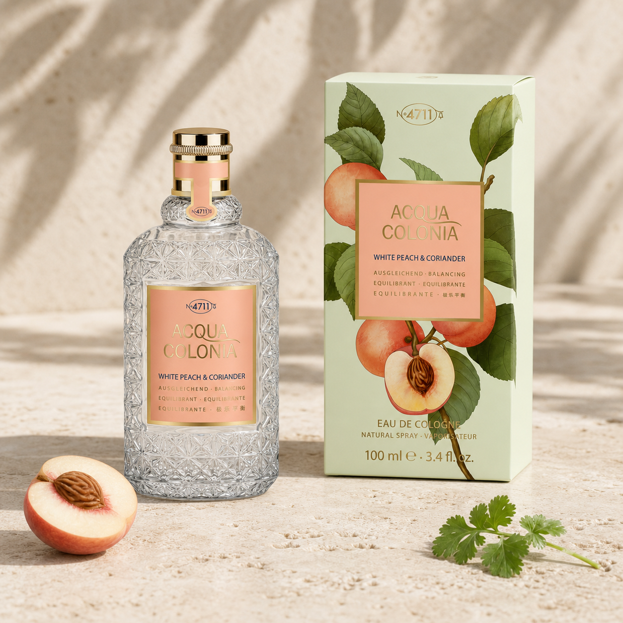 4711 Acqua Colonia White Peach and Coriander Eau de Cologne 100ml bottle and box in a sunlit stone setting