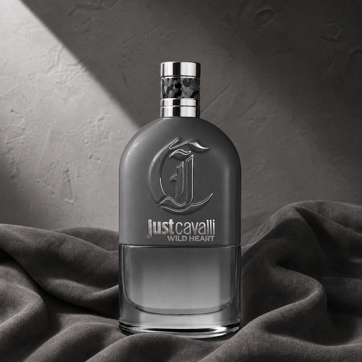 Just Cavalli Wild Heart Eau de Toilette 90ml bottle on charcoal suede