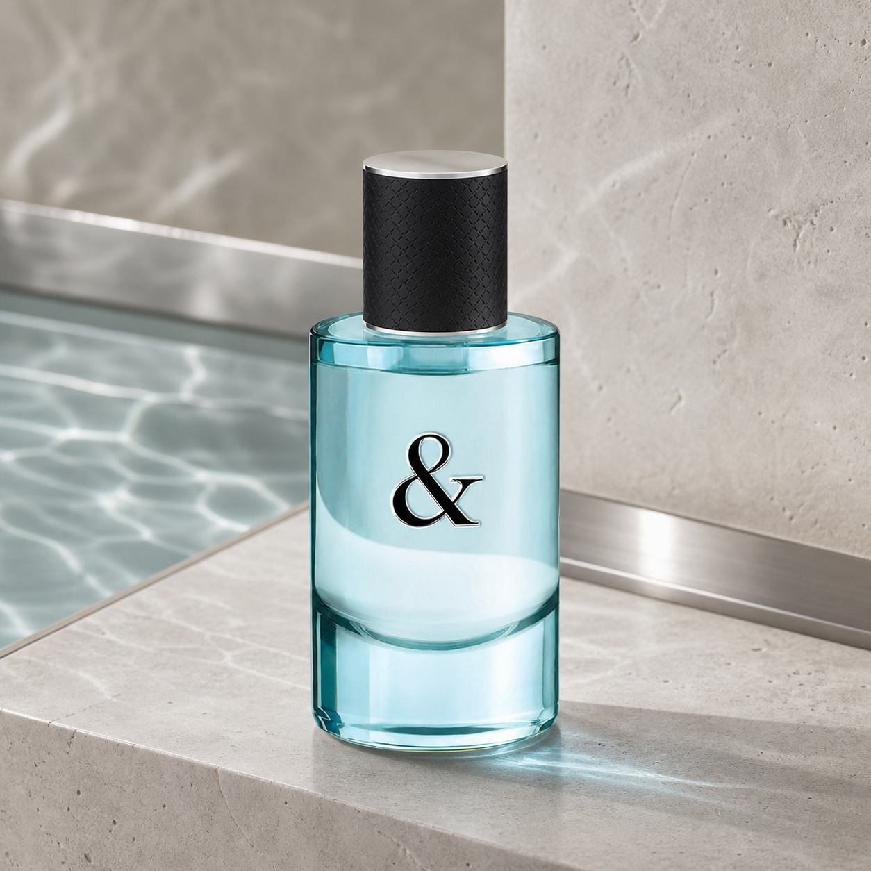Tiffany & Co Love for Him Eau de Toilette 50ml bottle beside a stone pool