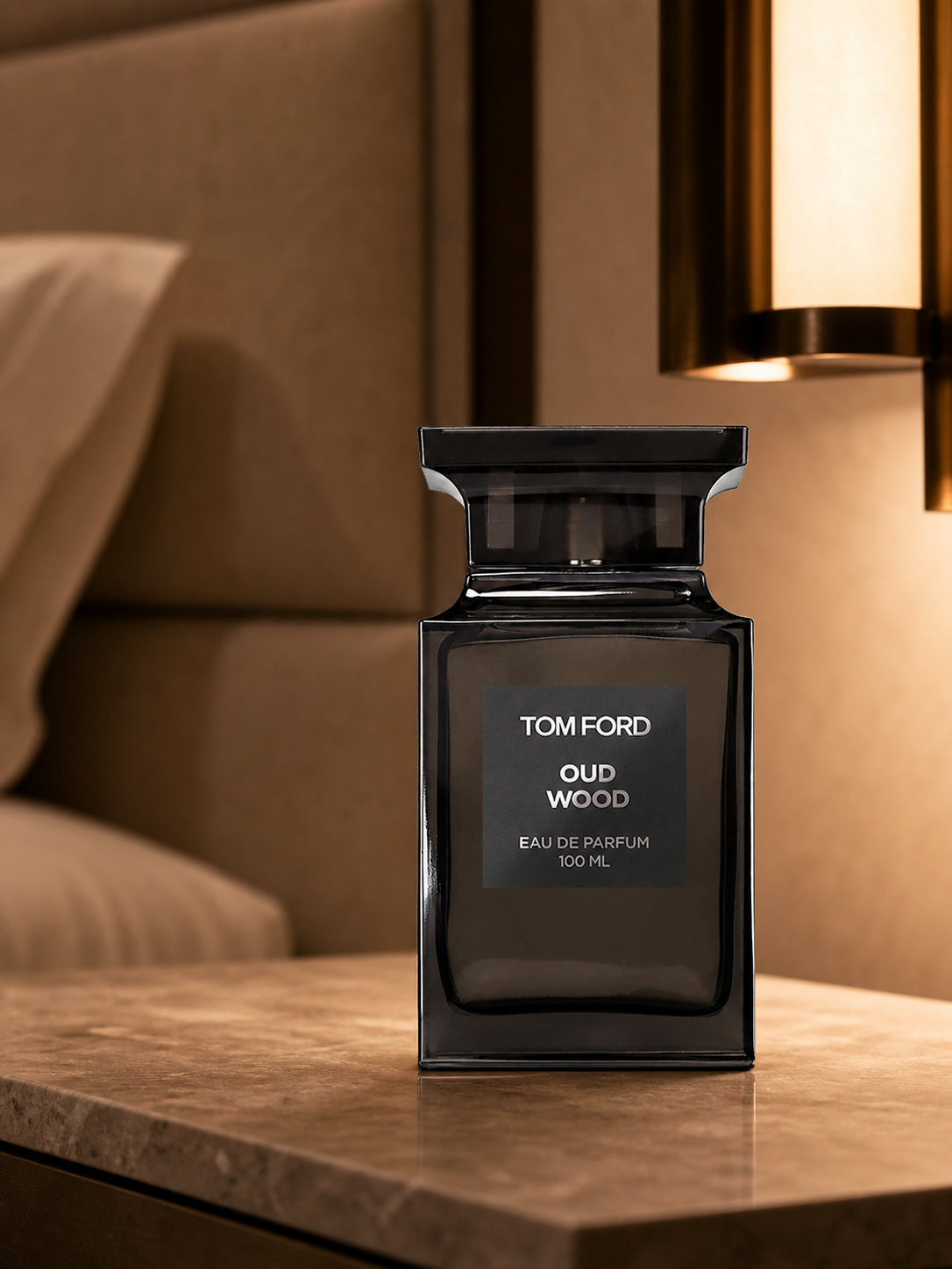 Tom Ford Oud Wood Eau de Parfum 100ml bottle on a hotel nightstand